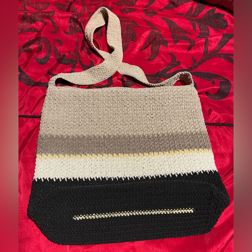 Hand-woven bag by Liz Claiborne. Beige, black, white and brown. 11L X 13W.